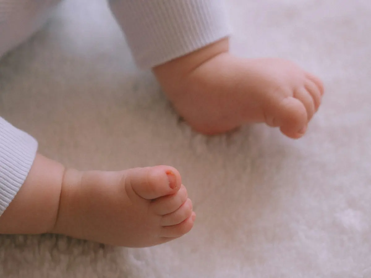 Füße eines Babys auf einer weißen Decke